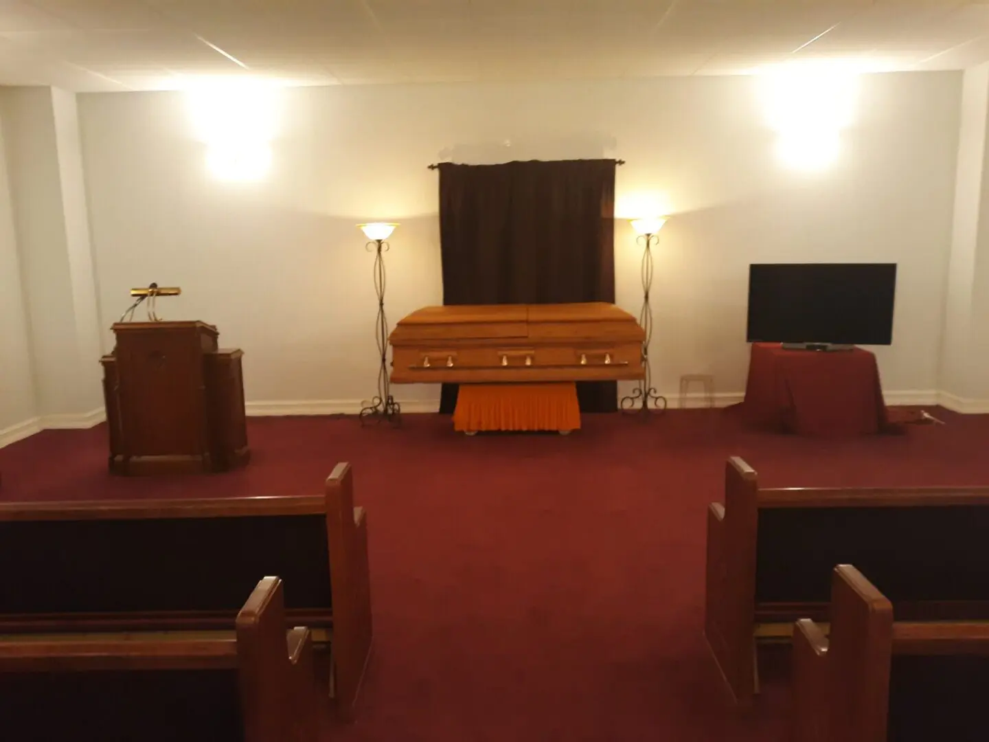 A Funeral Chapel Place With Red Color Carpet